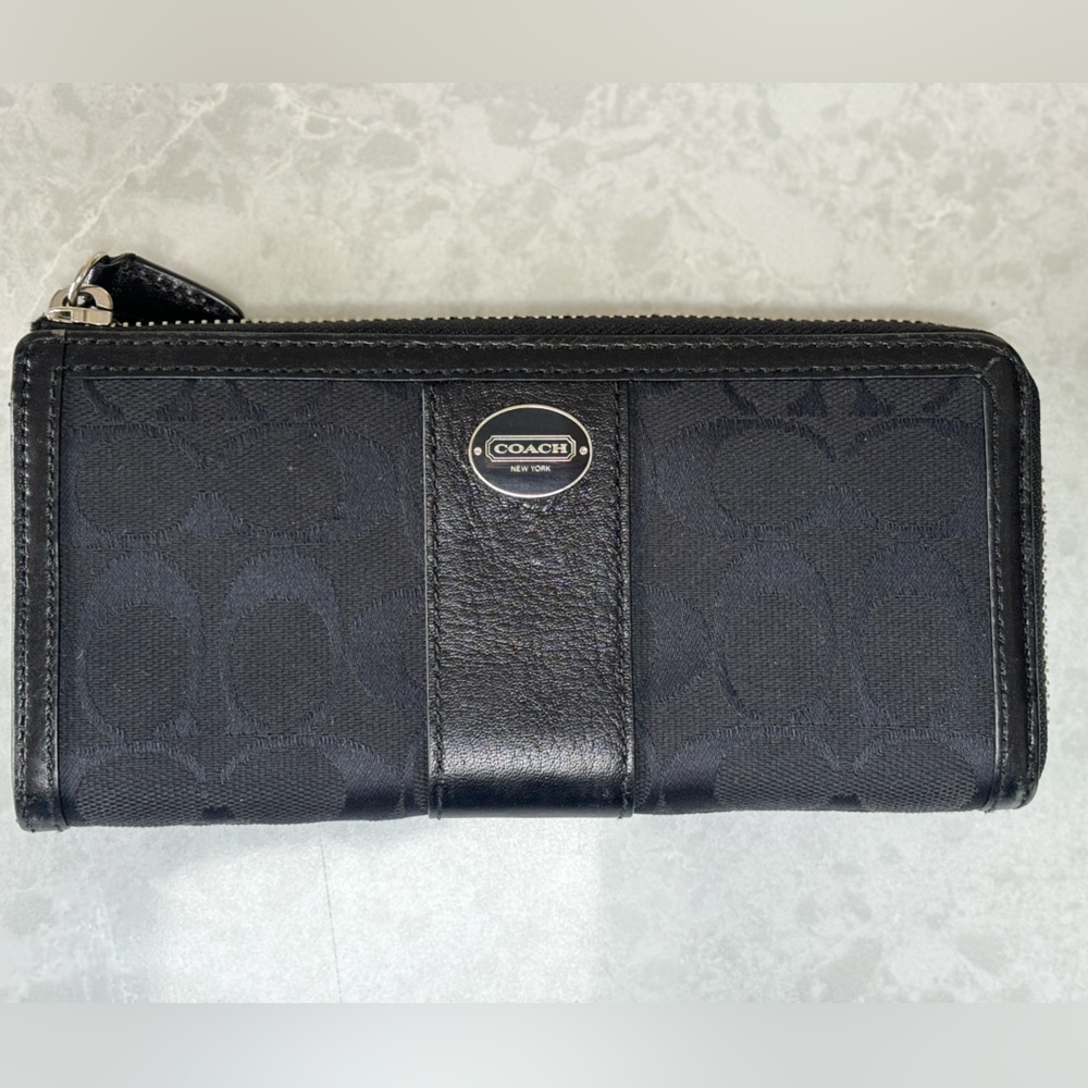 Coach C pattern zip wallet with black leather trim.